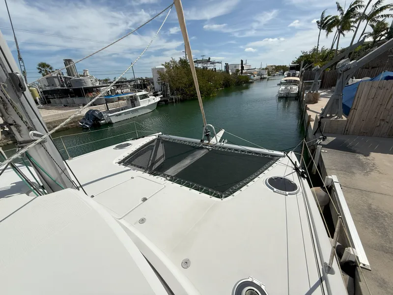 Slide: The Image of 2014 Fountaine Pajot Mahe 36 Evolution catamaran docked in a serene marina setting. - 7