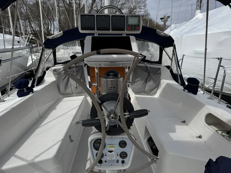 Slide: The Image of 1999 Catalina 36 Mk II sailboat cockpit with steering wheel and navigation instruments. - 1