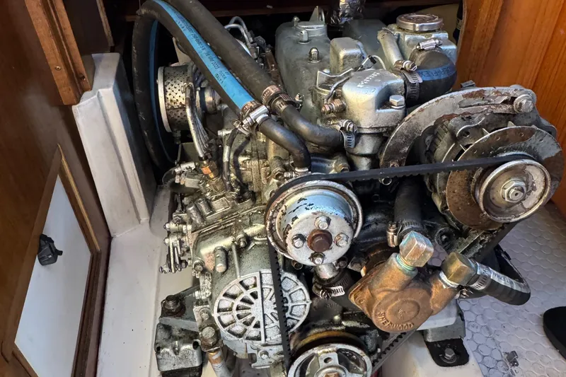 Slide: The Image of Engine of a 1999 Catalina 36 Mk II sailboat, showing mechanical components and hoses. - 13