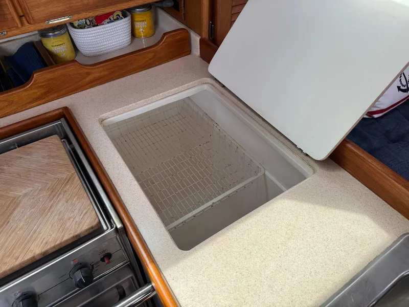 Slide: The Image of 1999 Catalina 36 Mk II yacht kitchen with open countertop storage. - 18