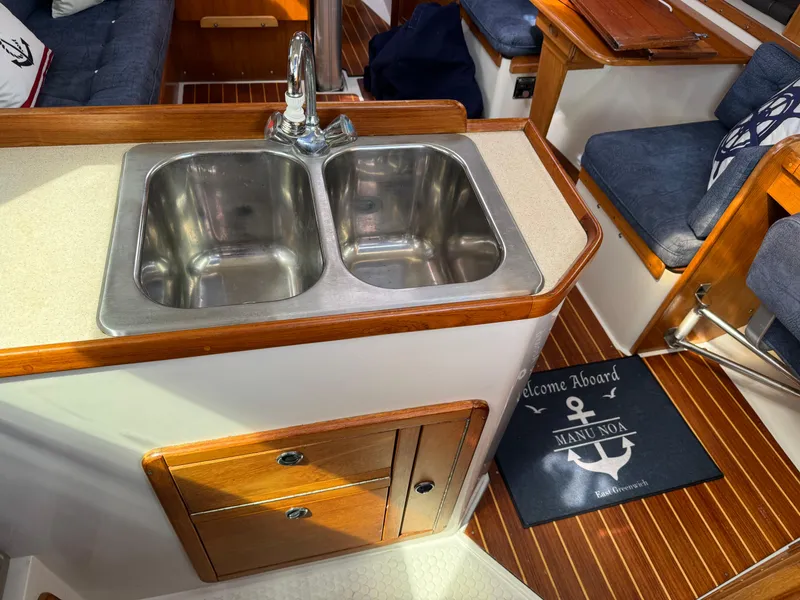 Slide: The Image of 1999 Catalina 36 Mk II yacht interior with dual sink and wooden cabinetry. - 22