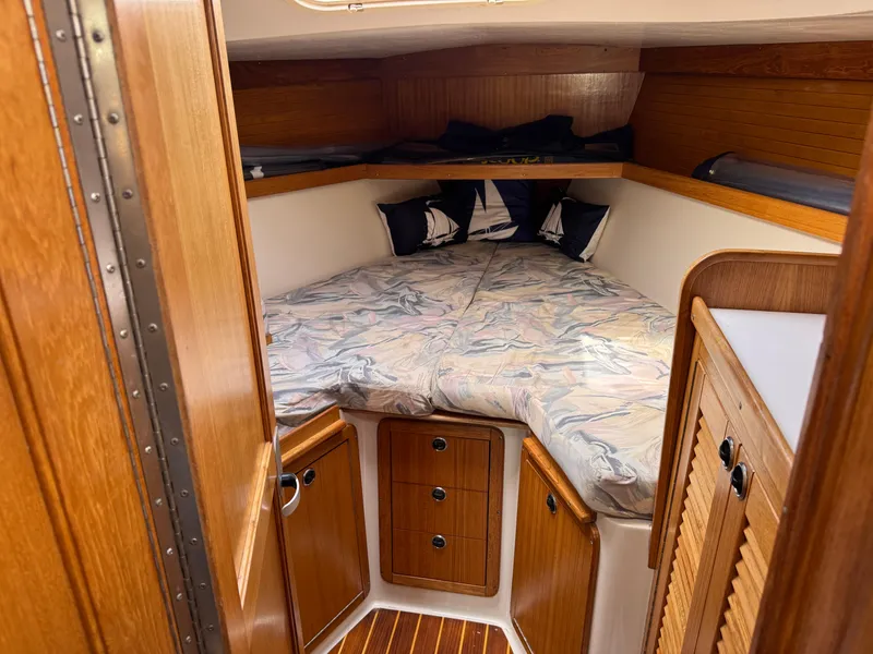 Slide: The Image of Cozy cabin interior of 1999 Catalina 36 Mk II sailboat with wooden finish and bedding. - 23