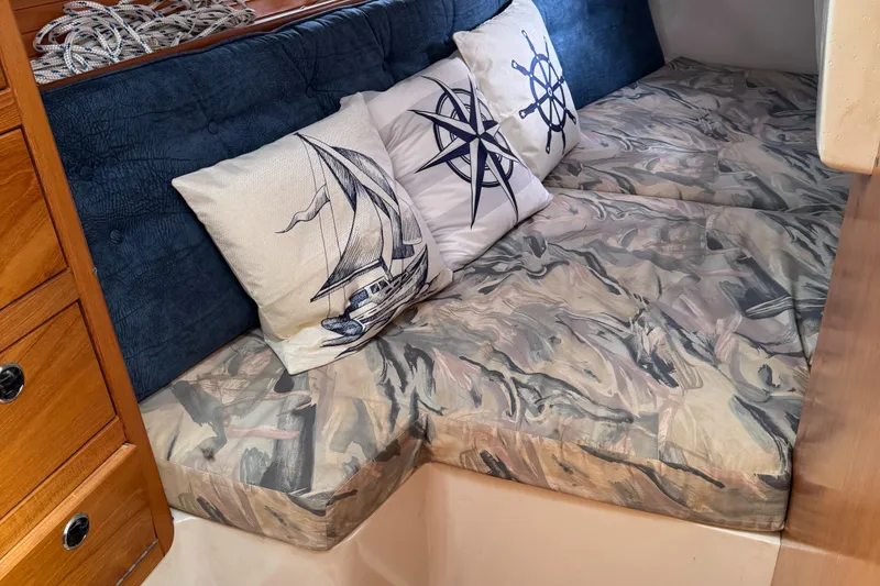 Slide: The Image of Cozy interior of 1999 Catalina 36 Mk II with nautical-themed cushions and patterned seating. - 34