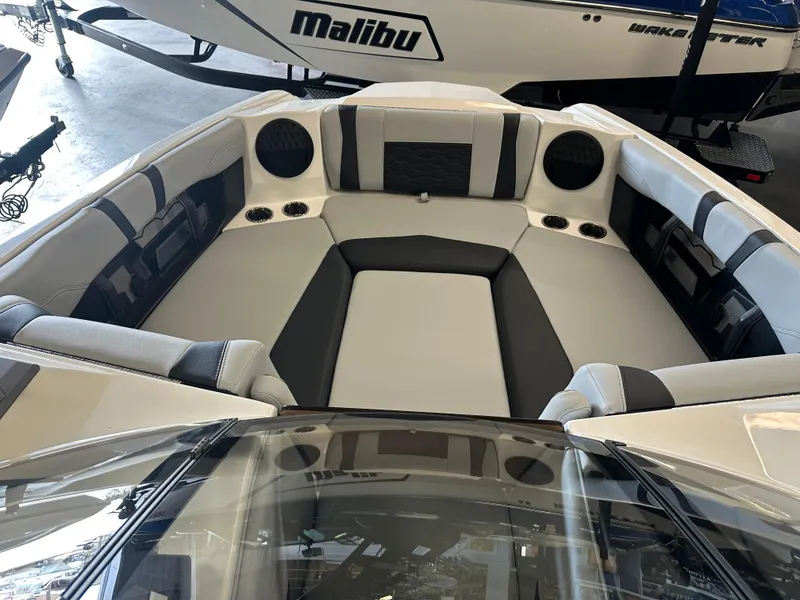 Slide: The Image of 2025 Malibu 23 MXZ boat interior with sleek seating and modern design. - 15