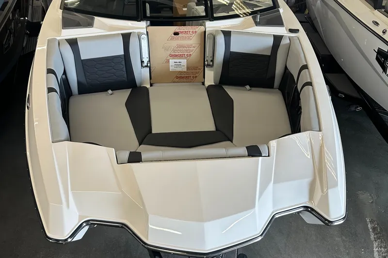 Slide: The Image of 2025 Malibu 23 MXZ boat interior with sleek seating design. - 3