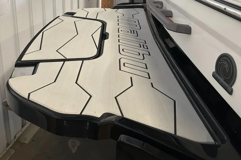 Slide: The Image of 2025 Malibu 23 MXZ boat swim platform with geometric design. - 4