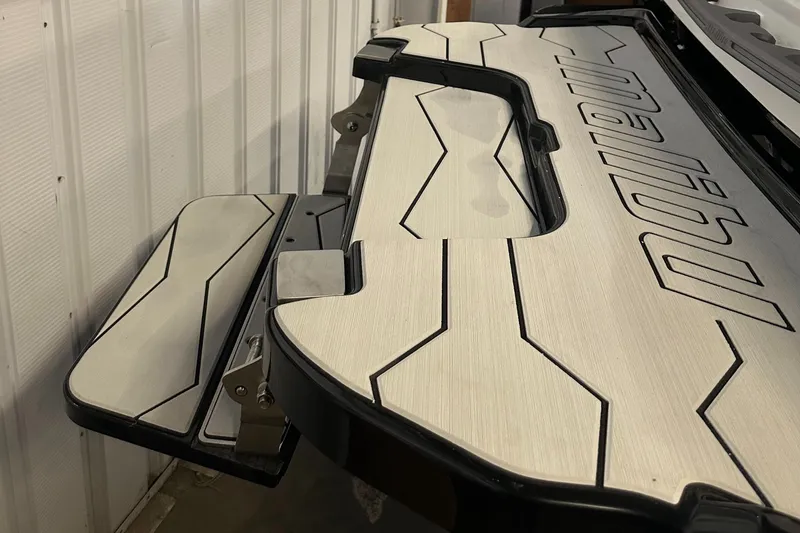 Slide: The Image of 2025 Malibu 23 MXZ boat swim platform with sleek design and modern detailing. - 5