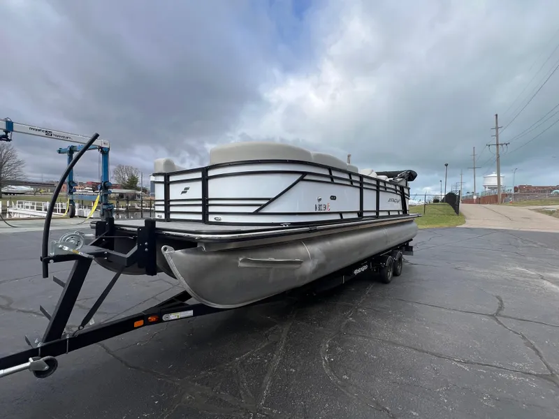 The Image of 2022 Starcraft SLS 5 pontoon boat on trailer under cloudy sky. - 0