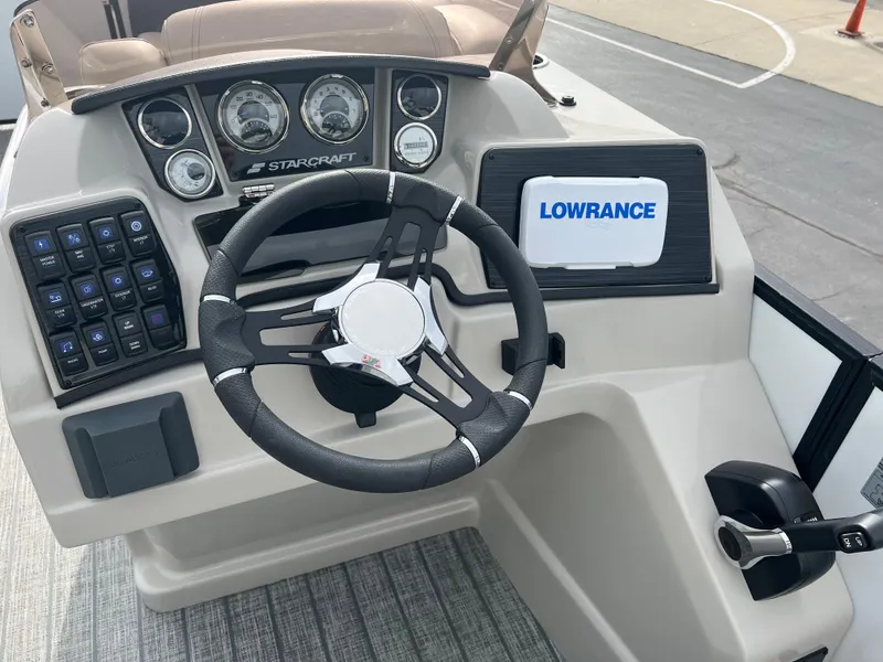 Slide: The Image of 2022 Starcraft SLS 5 boat dashboard with steering wheel and Lowrance display. - 6