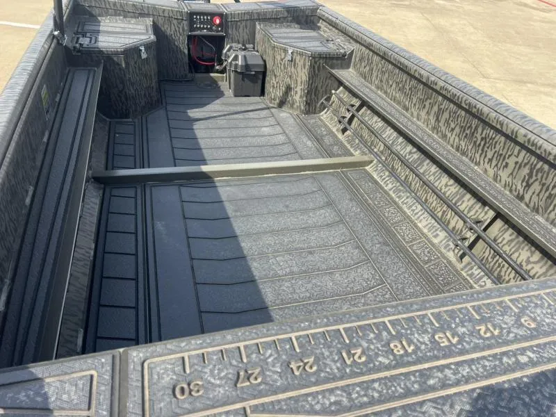 Slide: The Image of 2025 Gator Tail 17/50 Savage Series boat interior with textured flooring and storage compartments. - 11