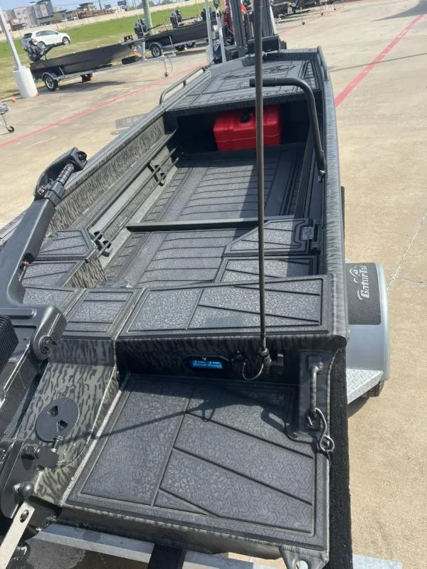 Slide: The Image of 2025 Gator Tail 17/50 Savage Series boat on trailer, featuring textured deck and storage compartment. - 15