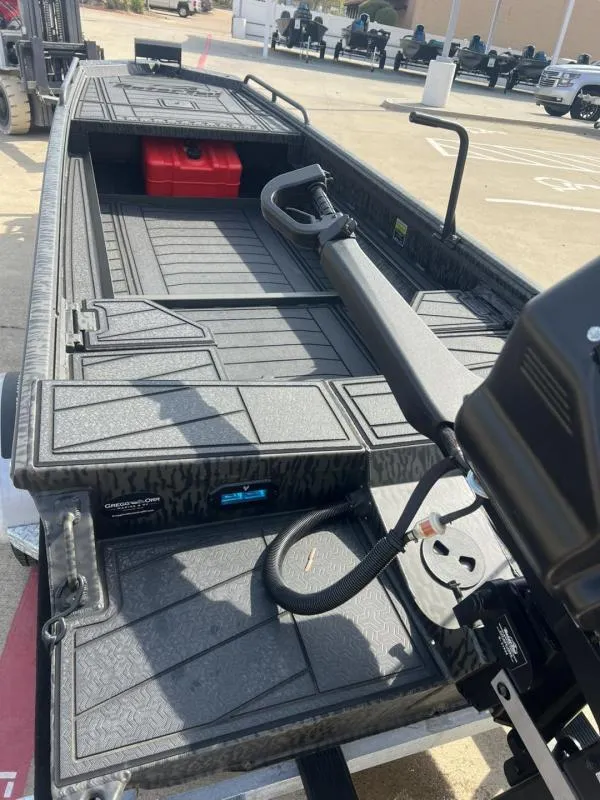 Slide: The Image of 2025 Gator Tail 17/50 Savage Series boat with motor, parked outdoors. - 16