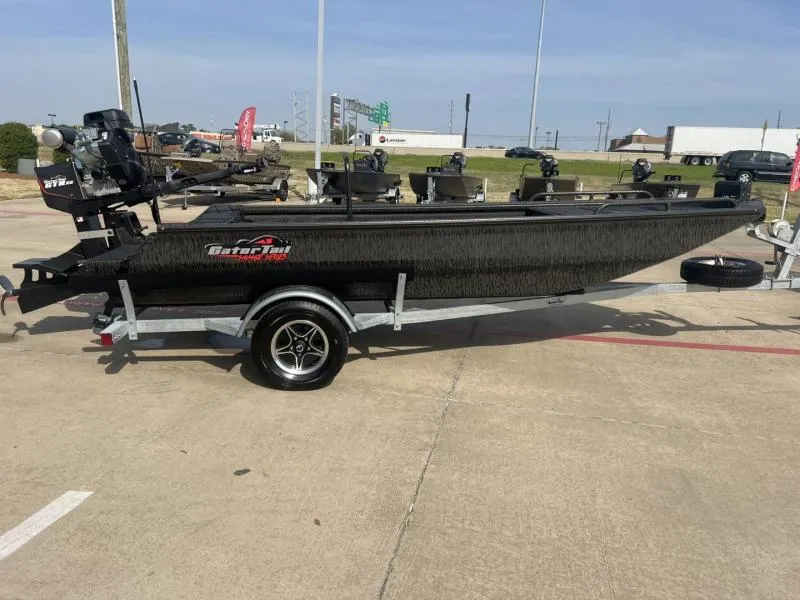 Slide: The Image of 2025 Gator Tail 17/50 Savage Series boat on trailer, parked outdoors. - 6