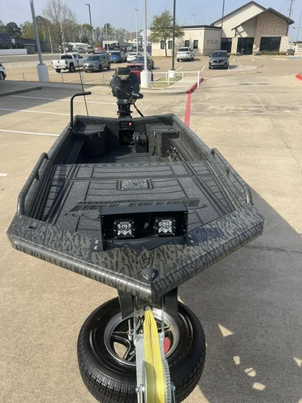 Slide: The Image of 2025 Gator Tail 17/50 Savage Series boat on trailer in parking lot. - 8