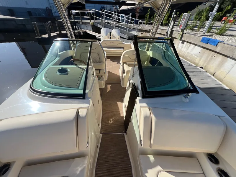 Slide: The Image of 2025 Chris-Craft Calypso 28 boat interior with open windshield and seating area. - 11