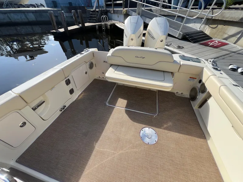 Slide: The Image of 2025 Chris-Craft Calypso 28 boat interior with seating and twin Mercury engines. - 19