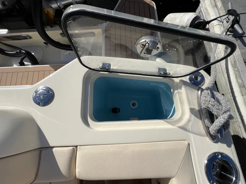 Slide: The Image of 2025 Chris-Craft Calypso 28 boat interior with open storage compartment and seating. - 20