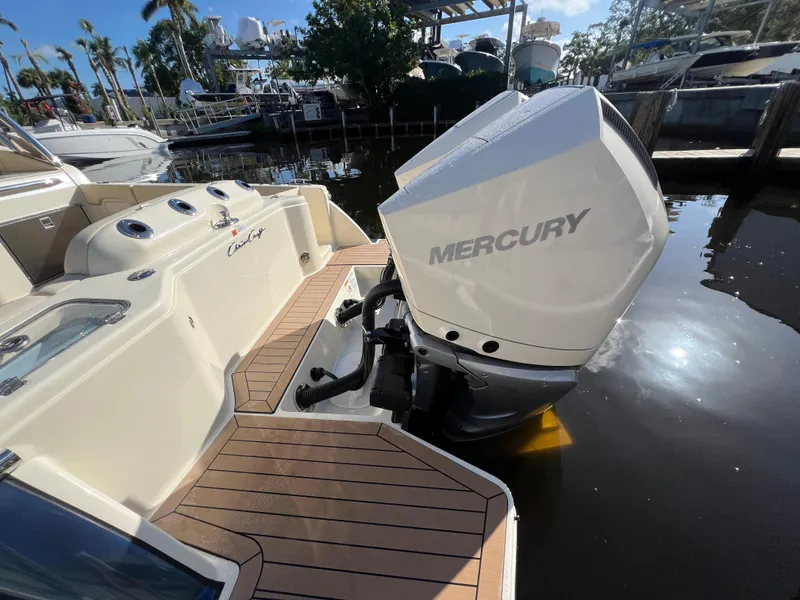 Slide: The Image of 2025 Chris-Craft Calypso 28 with Mercury outboard engine, docked in a marina. - 22
