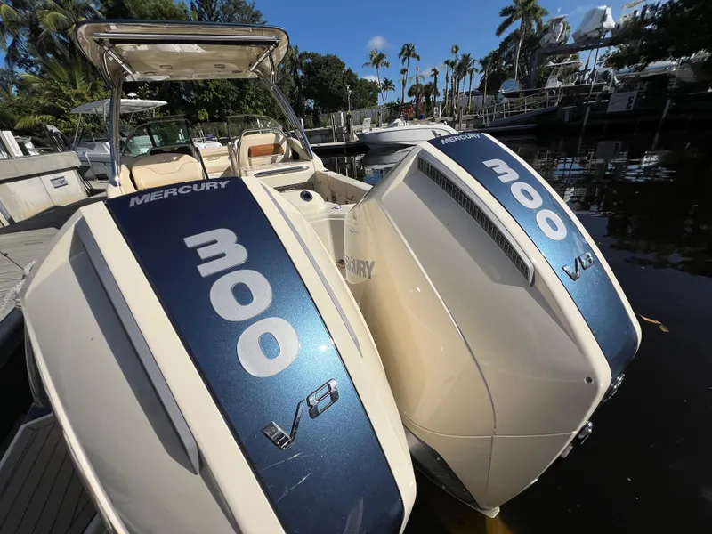 Slide: The Image of 2025 Chris-Craft Calypso 28 with twin Mercury 300 V8 engines docked by the water. - 23