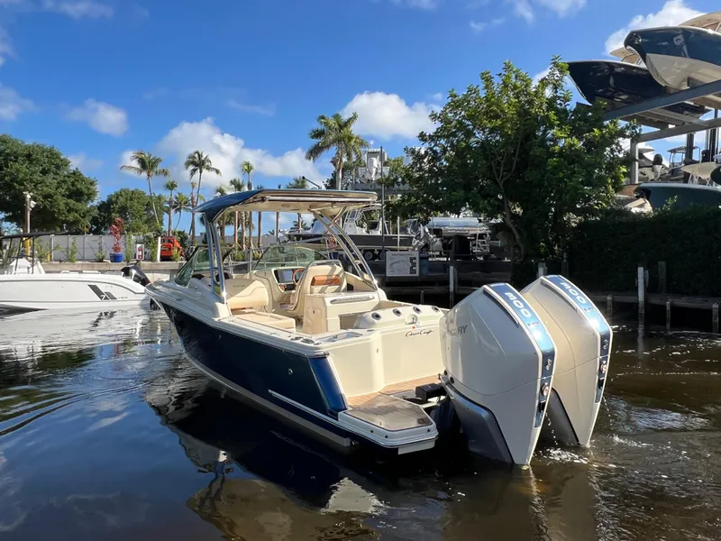 Slide: The Image of 2025 Chris-Craft Calypso 28 boat with dual Mercury engines on a sunny day. - 3
