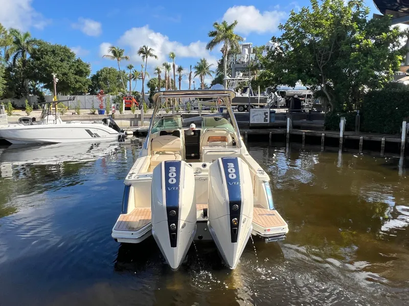 Slide: The Image of 2025 Chris-Craft Calypso 28 boat docked, featuring dual 300 V8 engines, surrounded by palm trees. - 4