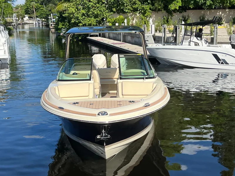 Slide: The Image of 2025 Chris-Craft Calypso 28 boat docked on a calm waterway. - 6