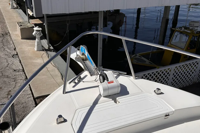 Slide: The Image of Bow of a 2006 Clearwater 2300 WA boat docked at a marina. - 23
