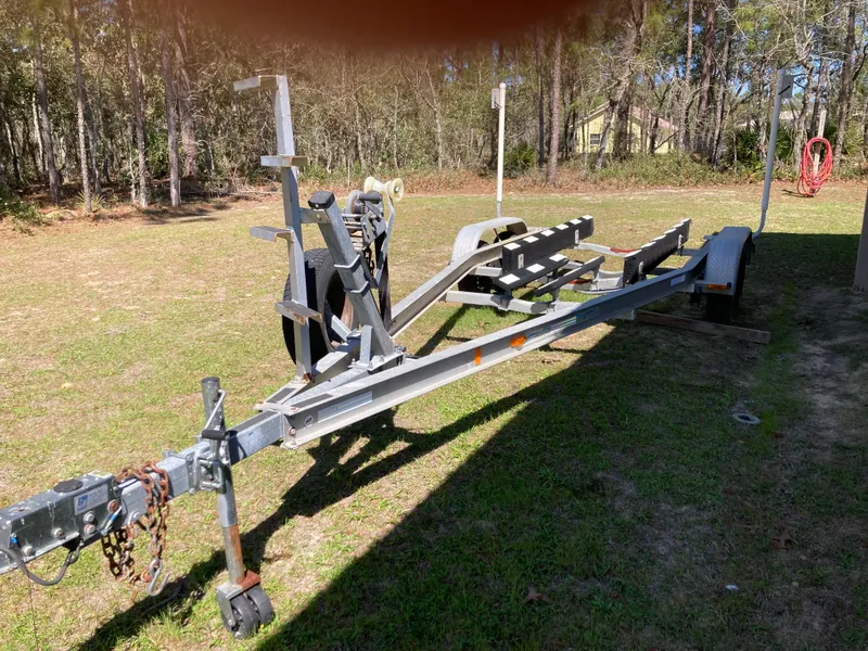 Slide: The Image of Trailer for 2006 Clearwater 2300 WA boat on grassy area. - 25