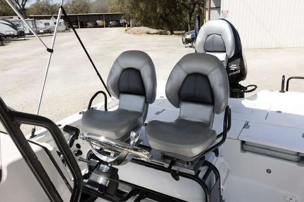 Slide: The Image of 2020 Blue Wave Pure Bay boat with dual gray seats and steering console. - 10