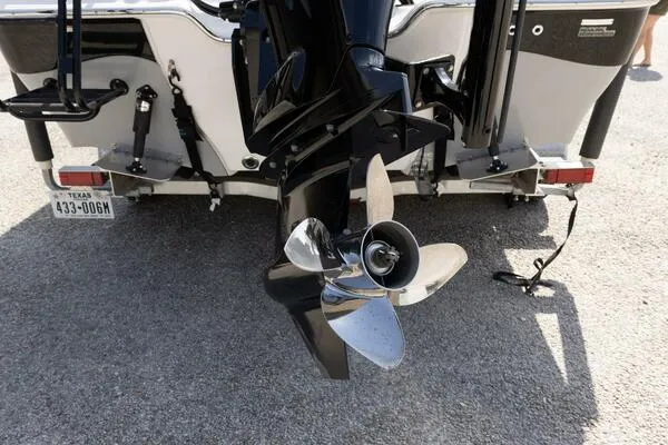 Slide: The Image of 2020 Blue Wave Pure Bay boat with a shiny propeller and Texas license plate. - 11