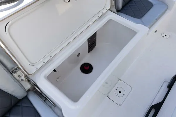 Slide: The Image of 2020 Blue Wave Pure Bay boat storage compartment with open lid, featuring cushioned seating. - 12