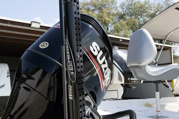 Slide: The Image of 2020 Blue Wave Pure Bay boat with Suzuki engine and Power-Pole Pro II, docked outdoors. - 13