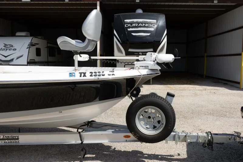 Slide: The Image of 2020 Blue Wave Pure Bay boat on trailer, parked near RV in storage facility. - 14