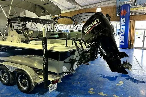 Slide: The Image of 2020 Blue Wave Pure Bay boat with Suzuki outboard motor on a trailer in a showroom. - 3