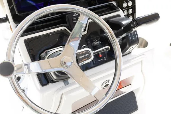 Slide: The Image of Steering wheel and controls of a 2020 Blue Wave Pure Bay boat. - 36