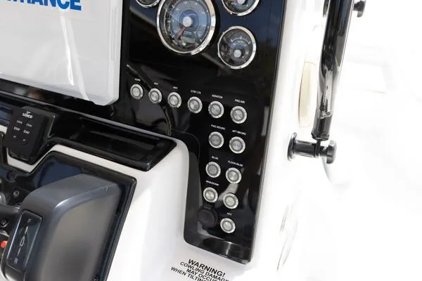 Slide: The Image of Control panel of a 2020 Blue Wave Pure Bay boat with various switches and gauges. - 37