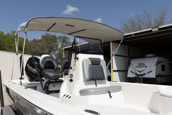 Slide: The Image of 2020 Blue Wave Pure Bay boat with canopy, parked near a Jayco trailer. - 43