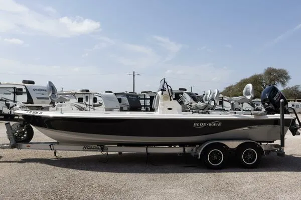 Slide: The Image of 2020 Blue Wave Pure Bay boat on trailer, parked outdoors under clear sky. - 45