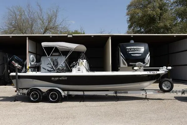 Slide: The Image of 2020 Blue Wave Pure Bay boat on trailer, parked outdoors. - 47