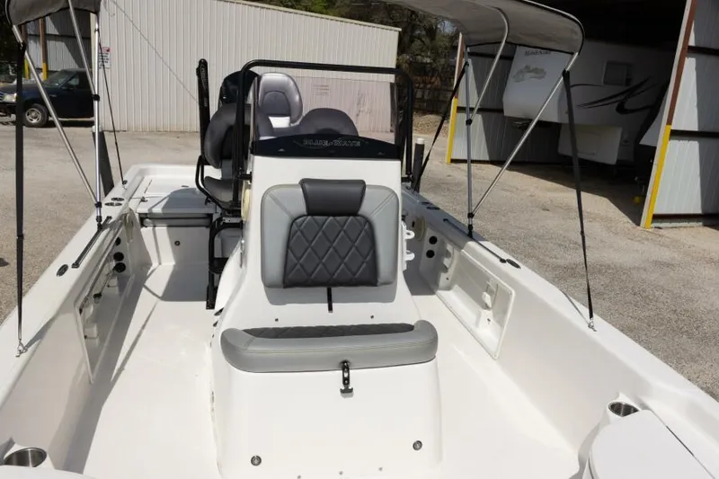 Slide: The Image of 2020 Blue Wave Pure Bay boat interior with seating and canopy in a storage area. - 9