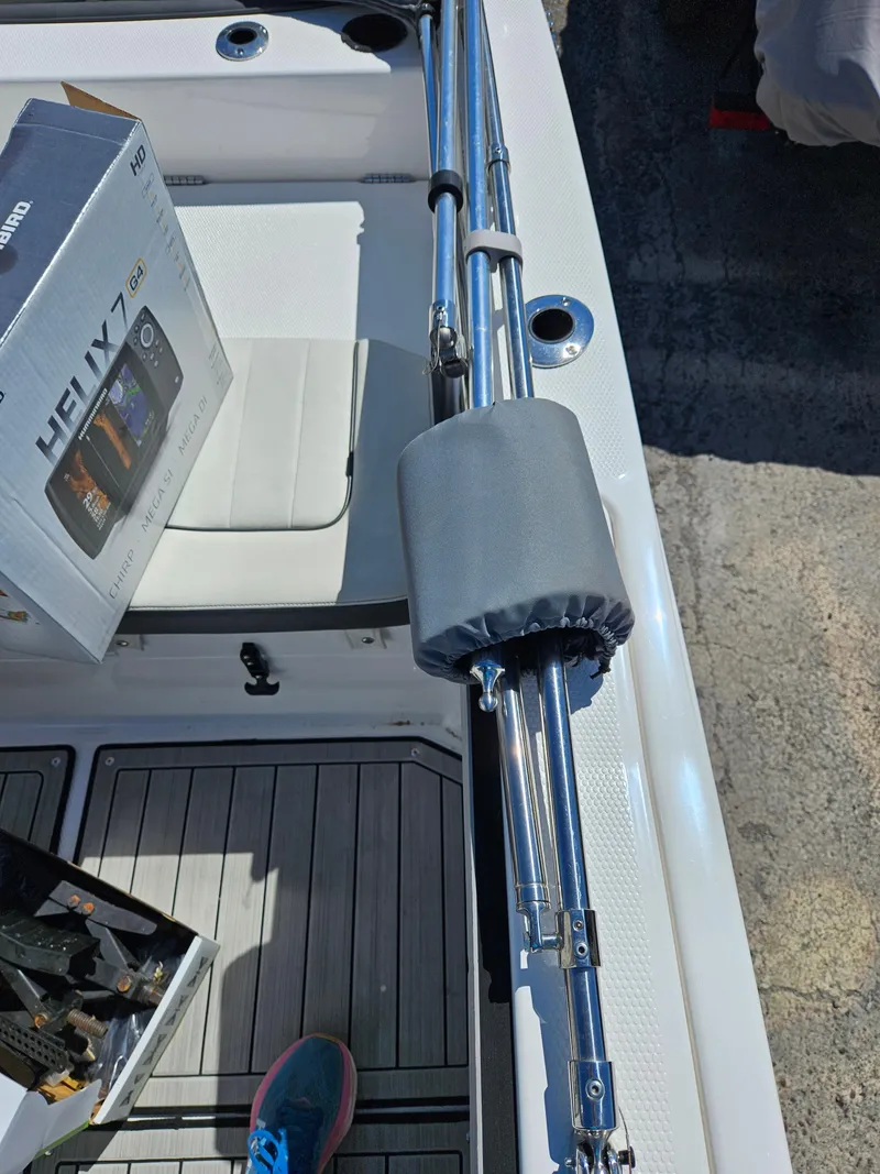 Slide: The Image of 2021 Yamaha Boats 210 FSH Deluxe deck with fishing equipment and electronics box. - 19