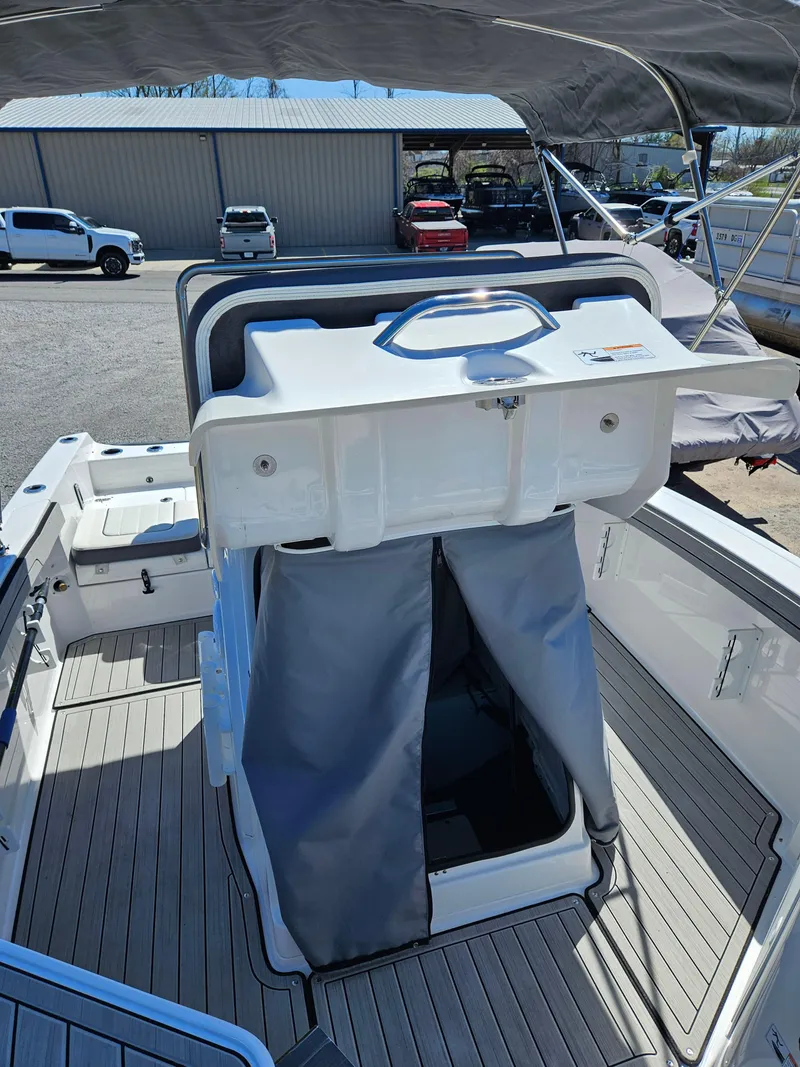 Slide: The Image of 2021 Yamaha Boats 210 FSH Deluxe interior with open storage compartment. - 20