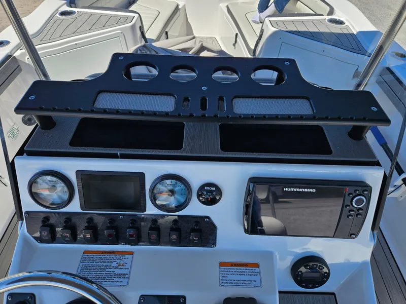 Slide: The Image of 2021 Yamaha Boats 210 FSH Deluxe dashboard with navigation and control instruments. - 25