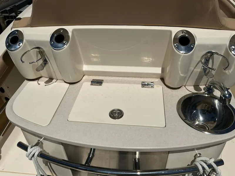 Slide: The Image of 2019 Scout 275 LXF boat sink and prep area with rod holders. - 11