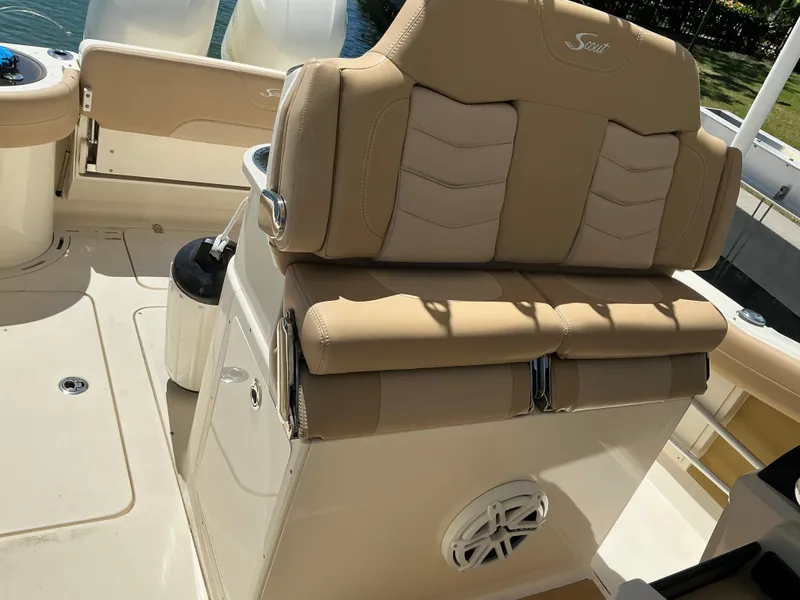 Slide: The Image of 2019 Scout 275 LXF boat interior with tan seating and storage compartment. - 14
