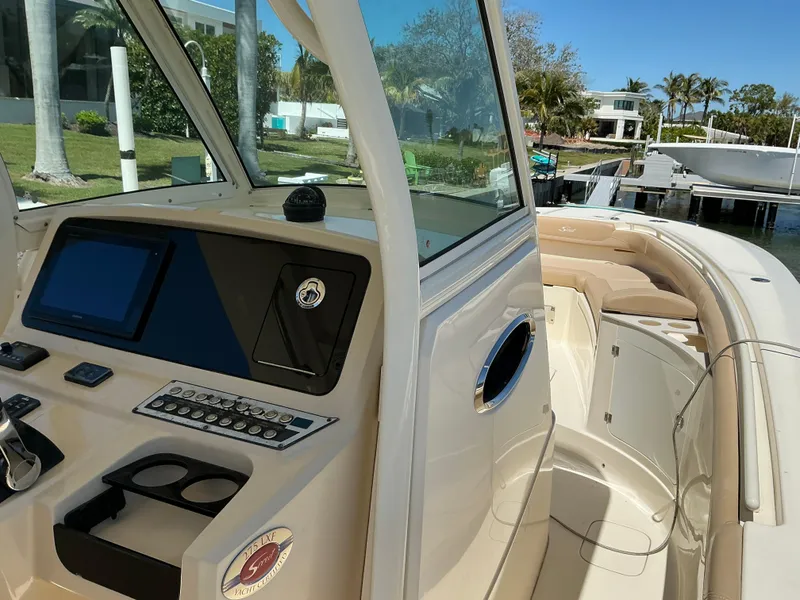 Slide: The Image of 2019 Scout 275 LXF boat interior with helm, seating, and modern controls. - 18