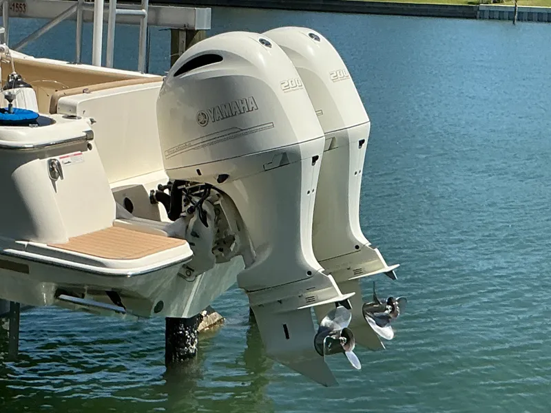 Slide: The Image of 2019 Scout 275 LXF boat with dual Yamaha outboard engines on water. - 2