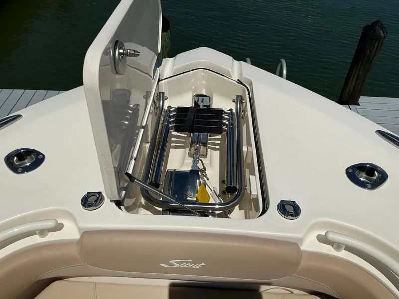 Slide: The Image of 2019 Scout 275 LXF boat anchor compartment with open hatch, dockside view. - 21