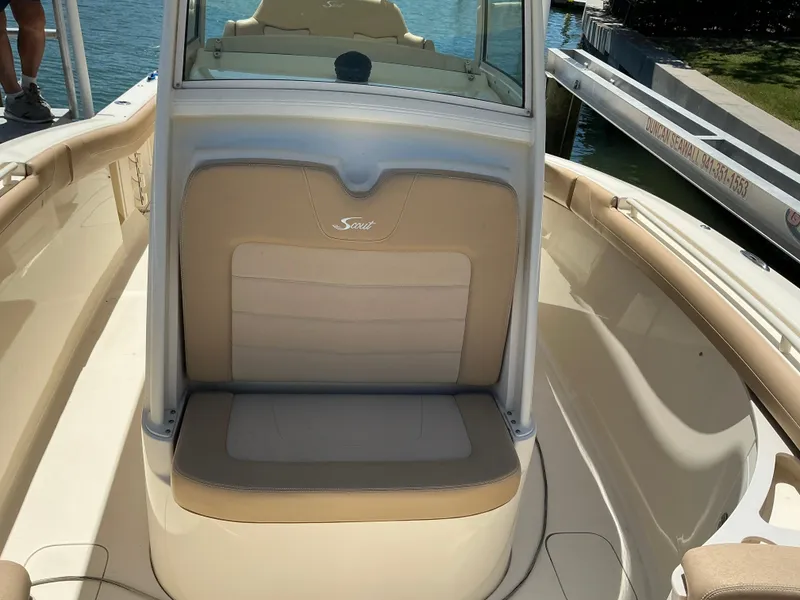 Slide: The Image of 2019 Scout 275 LXF boat interior with beige seating and console. - 22
