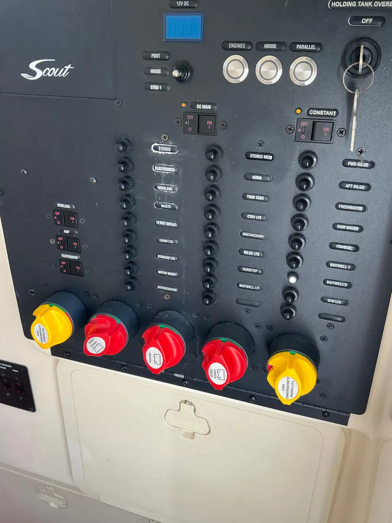 Slide: The Image of Control panel of a 2019 Scout 275 LXF boat with switches and dials. - 25